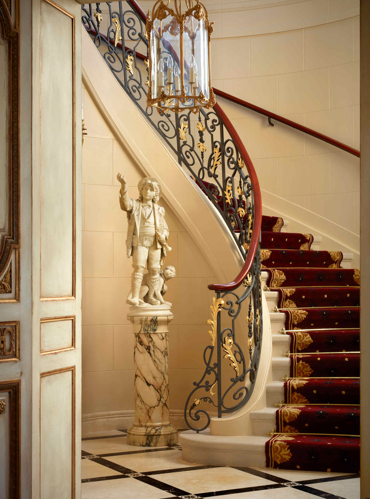 Hall de château avec un escalier et une lanterne